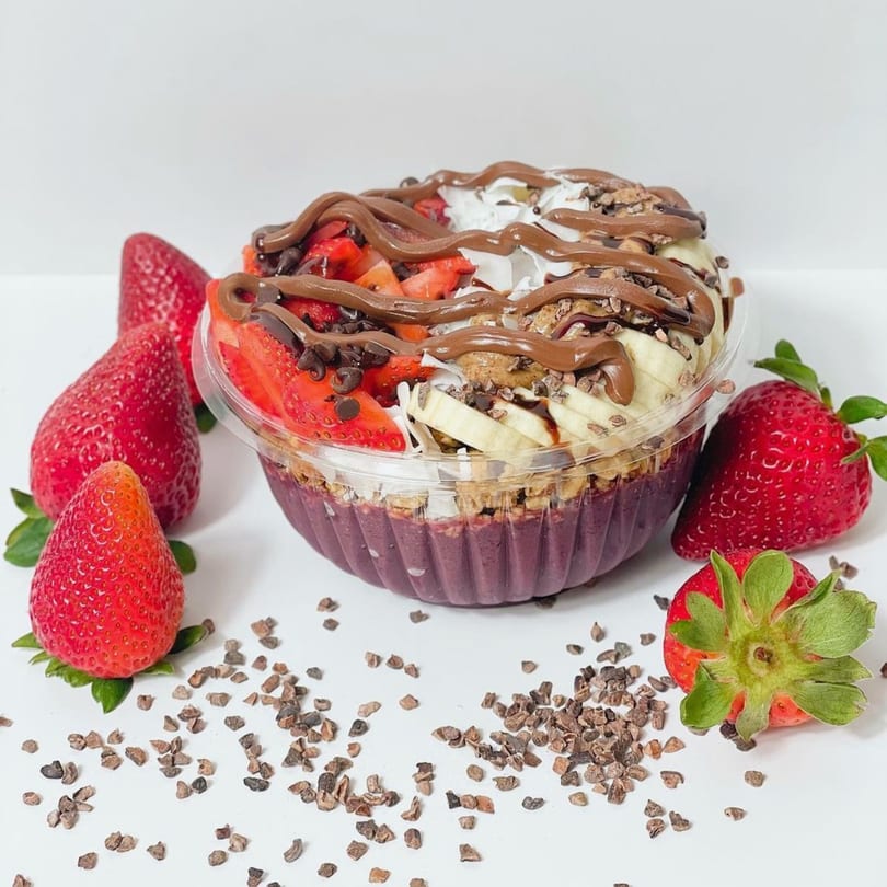 Vytal Nutrition's acai bowl with strawberries, bananas, chocolate drizzle, and cacao nibs.